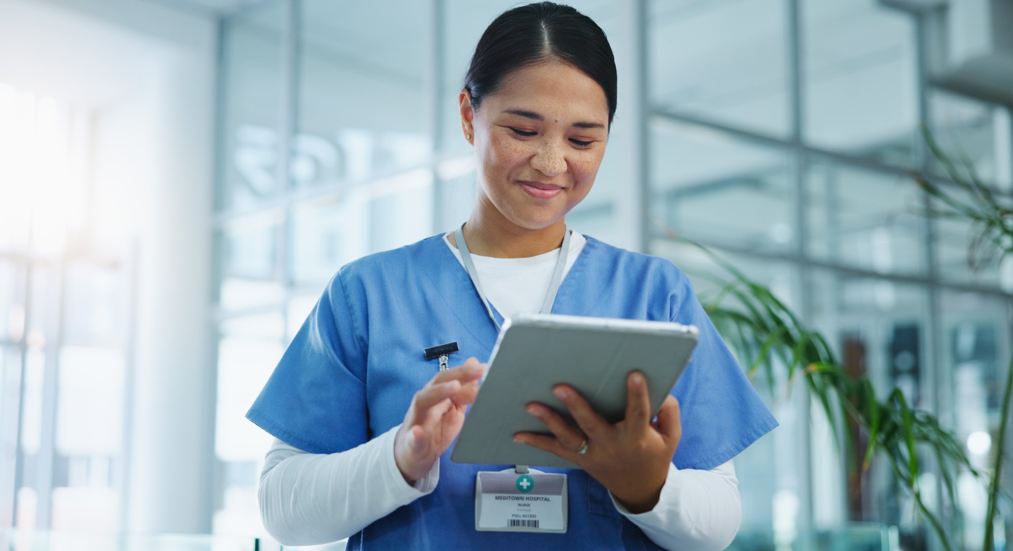 A nurse looking for information on her digital tablet